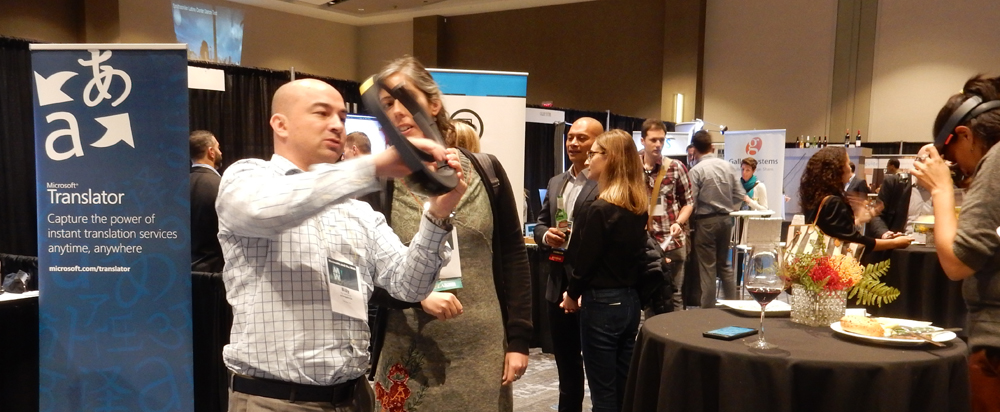 A vendor at MW17 fits a conference goer with a virtual reality headset.